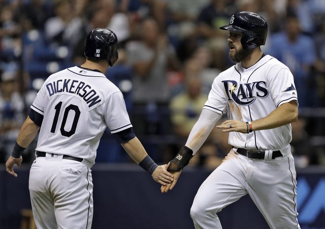 Tampa Bay Rays' Corey Dickerson (10) and Steven Souza Jr. celebrate after scoring on a two-run double by Logan Morrison off Cincinnati Reds relief pitcher Wandy Peralta earlier this season. [CHRIS O'MEARA/AP PHOTO]