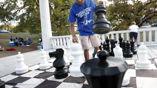 The large chess board at Wooldridge Square Park is out most Saturdays for parkgoers to play. AMERICAN-STATESMAN 2008