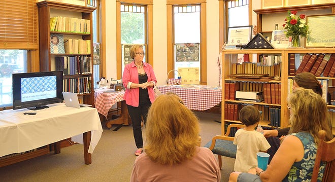 Judy DeLoria of Adrian gives a presentation on Laura Ingalls Wilder to open house attendees. [SAM FRY PHOTO]