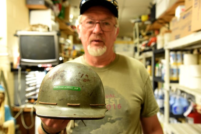 Al Compoly displays the liner from Frank Santacroce's helmet in the basement of St. Luke's Catholic Church in Stroudsburg. Compoly tracked down the family of the soldier who owned the World War II helmet. [Patrick Campbell/Pocono Record]