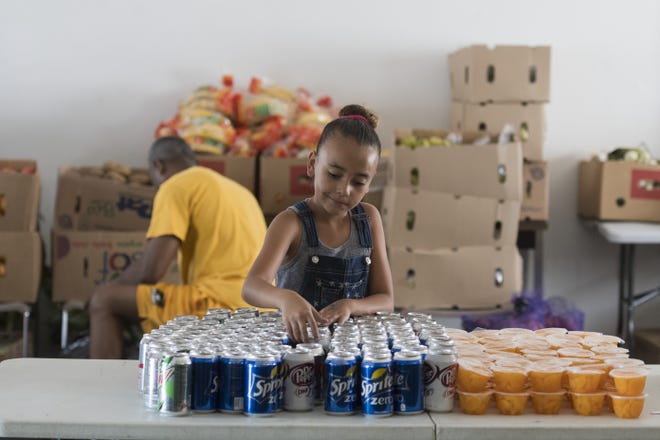 Another Level for Women offers their weekly food distribution at the Unity Center in Adelanto on Friday. The nonprofit has been threatened with eviction by the city for allegedly violating terms of its lease. [James Quigg, Daily Press]