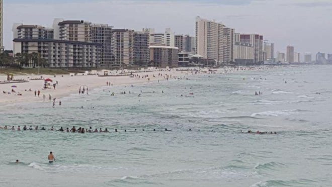 Beach goers formed a human chain in Panama City to rescue nine swimmers. (SPECIAL TO THE PANAMA CITY NEWS HERALD)