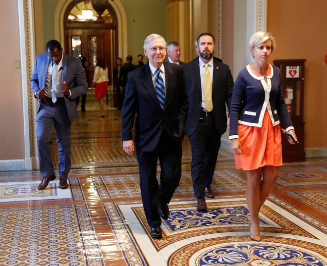 Senate Majority Leader Mitch McConnell of Ky., with his director of operations Stefanie Hagar Muchow, right, walks to his office on Capitol Hill in Washington, Tuesday, July 11, 2017. (AP Photo/Pablo Martinez Monsivais)