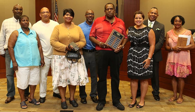 Relatives of Ransom Hunter stand together at the Mount Holly City Council meeting Monday evening, July 10, 2017 during the recognition of Hunter for being named the 2017 Mount Holly Historic Person of the Year. Pictured third from right is Mount Holly Historical Society President Mary Smith. Hunter's descendants, from left, include Jeffery Wilson, Lisa Wilson Bailey, Dean Boyles, Felicia Wilson, Nahshun Sifford, Grady Wilson, Eric Van Wilson, and Wanda Holloway. [Mike Hensdill/The Gaston Gazette]