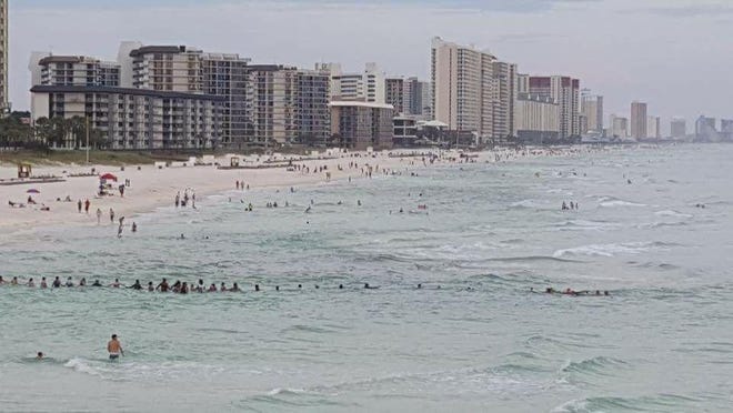 Beachgoers formed a human chain near the M.B. Miller County Pier on Saturday afternoon off Panama City Beach to rescue nine swimmers who were drowning. [SPECIAL TO THE PANAMA CITY NEWS HERALD]
