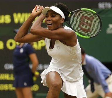 Venus Williams hits a return during her win over Jelena Ostapenko in a quarterfinal singles match at the Wimbledon Tennis Championships in London on Tuesday. [AP Photo/Alastair Grant]