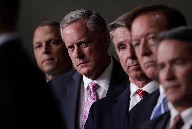 House Freedom Caucus Chairman Rep. Mark Meadows, R-N.C., second from left, and others, participates in a news conference on Capitol Hill in Washington, Wednesday, July 12, 2017, to say that his group wants to delay the traditional August recess until work is accomplished on health care, the debt ceiling and tax reform. (AP Photo/J. Scott Applewhite)