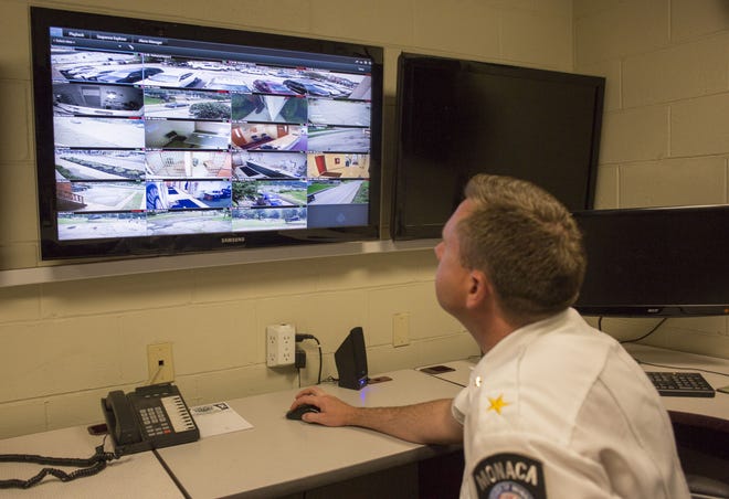 Police Chief Dave Puiri looks at video of the parking lot next to the Monaca municipal building at the top of the screen Wednesday inside the Monaca police station. The parking lot will serve as a safe exchange zone where people can do custody exchanges and Craigslist transactions.