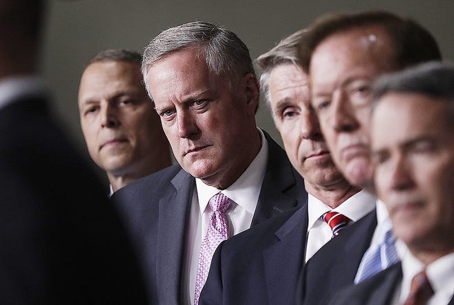 House Freedom Caucus Chairman Rep. Mark Meadows, R-N.C., second from left, and others, participates in a news conference on Capitol Hill in Washington Wednesday to say that his group wants to delay the traditional August recess until work is accomplished on health care, the debt ceiling and tax reform. [J. SCOTT APPLEWHITE/ASSOCIATED PRESS]