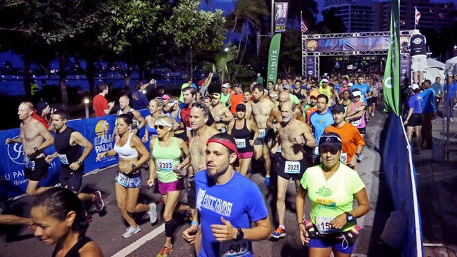 Runners start the Eau Palm Beach Marathon along Flagler Drive in downtown West Palm Beach on Dec. 6, 2015. (Richard Graulich / The Palm Beach Post)