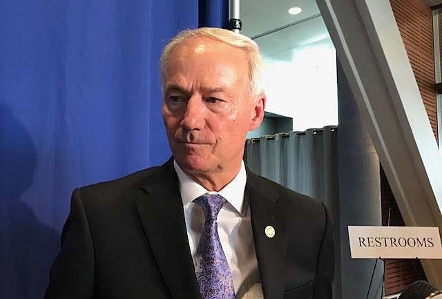 Gov. Asa Hutchinson talks to reporters Tuesday at the Clinton Presidential Library after giving a talk to the Little Rock Rotary Club. [John Lyon/Arkansas News Bureau]