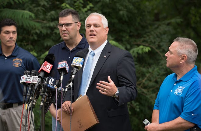 Bucks County DA Matthew Weintraub (center) holds a press conference concerning the search for four missing men Tuesday, July 11, 2017, in Solebury.