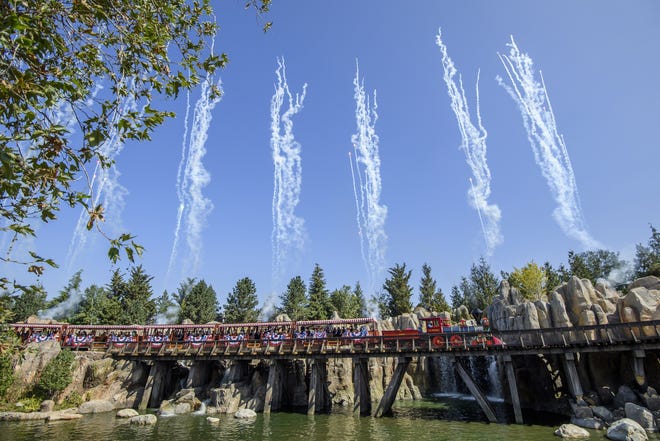 Streamers and fireworks fly as the Disneyland Railroad makes its return. [Richard Harbaugh/Disneyland]