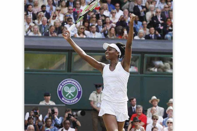 Venus Williams celebrates after beating Johanna Konta in a semifinal match at the Wimbledon Tennis Championships in London on Thursday.