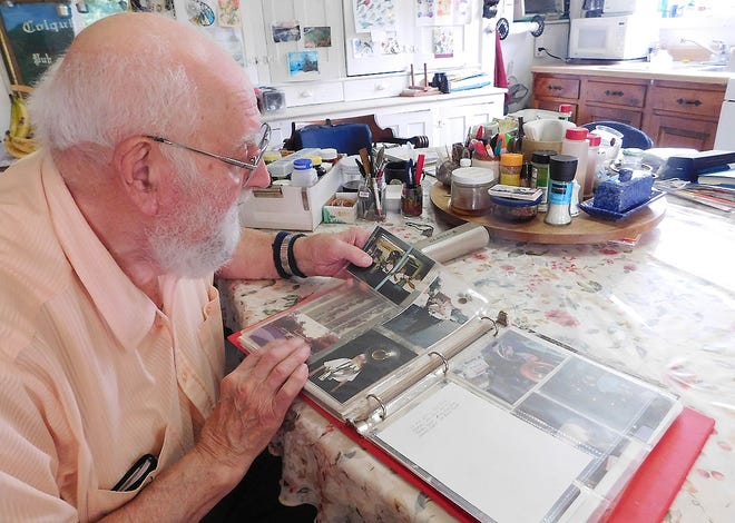 Roscoe “Rocky” Reed looks at a picture from one of the bands he used to participate in during a recent visit to his home in Ilion. Reed has performed with the Ilion Civic Band for the past 70 years. [STEPHANIE SORRELL-WHITE/TIMES TELEGRAM]