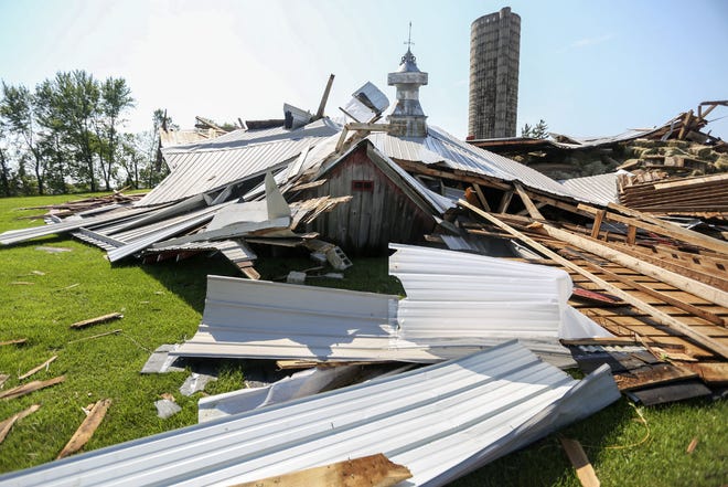 Debris lies on the ground at the Bahl Family Farm lies on the ground in Asbury, Iowa, after storm moved through the area. Authorities say a tornado has damaged farmsteads and crop fields and high winds from other storms have torn at homes and knocked out power in eastern Iowa. (Nicki Kohl/Telegraph Herald via AP)