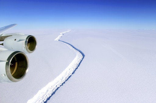This Nov. 10, 2016 aerial photo released by NASA, shows a rift in the Antarctic Peninsula's Larsen C ice shelf. A vast iceberg with twice the volume of Lake Erie has broken off from a key floating ice shelf in Antarctica, scientists said Wednesday July 12, 2017 . The iceberg broke off from the Larsen C ice shelf, scientists at the University of Swansea in Britain said. The iceberg, which is likely to be named A68, is described as weighing 1 trillion tons (1.12 trillion U.S. tons).(John Sonntag/NASA via AP)