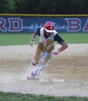 Ballard’s Reece Huen sprints home while rounding third base for one of his three runs during the Bombers’ 11-1 victory over Carroll in five innings July 6 at Slater. Huen tripled, walked twice and scored three times on his birthday.