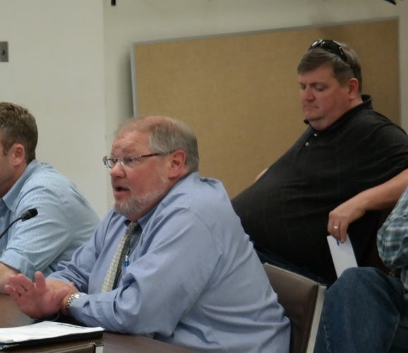 Sean O'Brien, director of the Barnstable County Department of Health and Environment, earlier this summer. Behind him, Commissioner Ronald Beaty Jr.