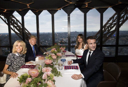 President Donald Trump, first lady Melania Trump, French President Emmanuel Macron his wife Brigitte Macron, are photographed as they sit for dinner at the Jules Verne Restaurant on the Eiffel Tower in Paris, Thursday, July 13, 2017. (AP Photo/Carolyn Kaster)