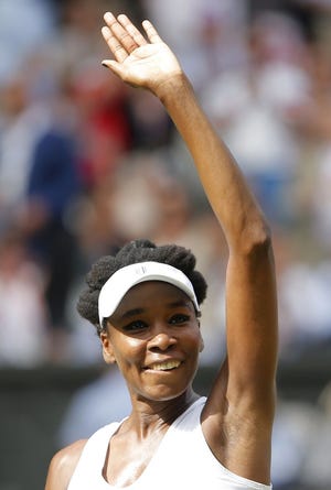 Venus Williams waves after beating Johanna Konta in one of Thursday’s women’s singles semifinals at Wimbledon.