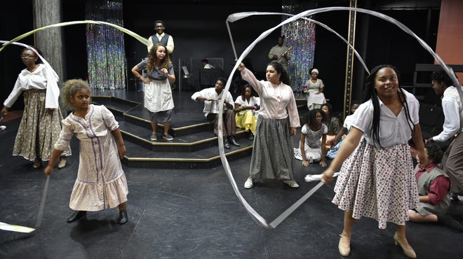 Sarasota's Westcoast Black Theatre Troupe's annual free summer camp "Stage of Discovery." Standing, from left, Kourtney Drew, Alitash Tafesse, Astrid McIntyre, Todd Bellamy II, Marielena Savino and Daysha Brown, along with the rest of the cast, rehearse 'Brer Tiger & the Big Wind.' [HERALD-TRIBUNE STAFF PHOTO / THOMAS BENDER]