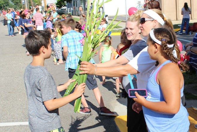 Jacquie Ward of Portage was the recipient of a bouquet of gladiolas Friday at the Covered Bridge Days parade. The flowers, distributed randomly to dozens of others in attendance, were compliments of Centreville attorney Kevin Kane.