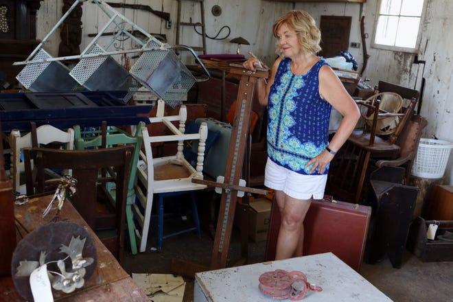 Linda Clifton, who sells repurposed furniture, antiques and re-imagined items, stands in a storage building that doubles as a bar at her wedding venue The Farmers Daughter Friday near Stronghurst, Ill. Clifton is one the vendors selling items at the Very Vintage Market today in downtown Burlington.