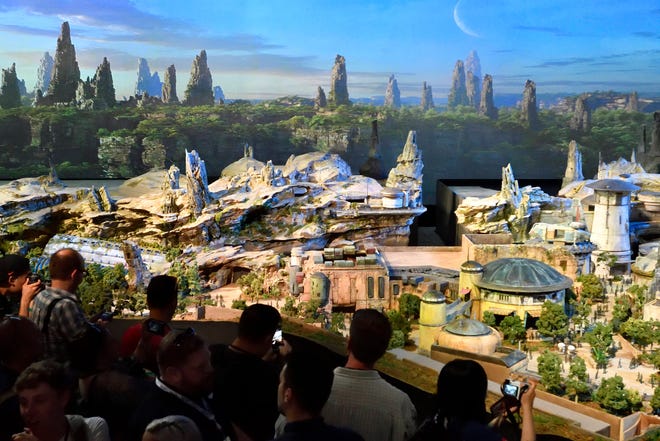 Members of the media get their first look at a 50-foot, detailed model of “Star Wars” land during a media preview for Disney’s D23 Expo in Anaheim, Calf., on Thursday, July 13, 2017. (Jeff Gritchen/The Orange County Register via AP)