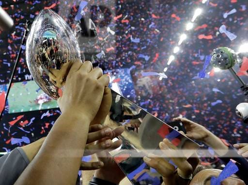 New England Patriots players hoist the Vince Lombardi Trophy after winning Super Bowl LI in overtime on Sunday, Feb. 5, 2017, in Houston. (AP Photo/Eric Gay)