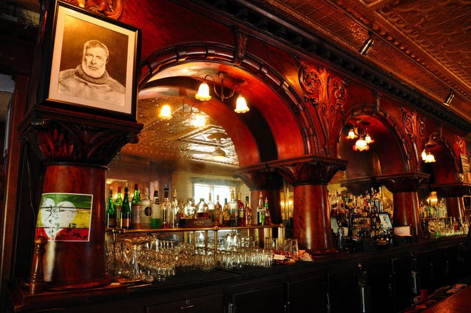 A portrait of Ernest Hemingway looks down from the mahogany bar at City Park Grill in Petoskey, Michigan. [KATHERINE RODEGHIER/CHICAGO TRIBUNE]