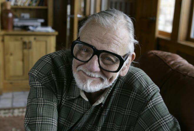 In this 2008 file photo, director and writer George Romero poses for a photograph while talking about his film "Diary of the Dead' at the Sundance Film Festival in Park City, Utah. George Romero, whose classic "Night of the Living Dead" and other horror films turned zombie movies into social commentaries and who saw his flesh-devouring undead spawn countless imitators, remakes and homages, has died. He was 77. Romero died Sunday following a battle with lung cancer. [AP Photo/Amy Sancetta, File]