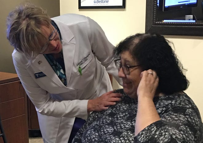 Joanne Gillespie, hearing care practitioner at Beltone in Dartmouth, helps fit Rosa Oliveira of New Bedford with new hearing aids. [CONTRIBUTED PHOTO]