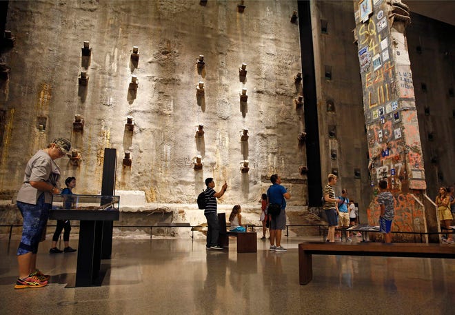 In this July 11, 2017 photo, visitors to the Foundation Hall at the National September 11 Memorial and Museum view the slurry wall, rear, and a beam from one of the World Trade towers, right, that was preserved by rescue and recovery workers at the site in New York. Last winter the U.S. tourism industry worried about a “Trump slump,” fearing that Trump administration policies might discourage international travelers from visiting the U.S. But statistics from the first half of 2017 suggest that the travel to the U.S. is robust and a number of sectors have reported increased international visitation, with one expert calling it a “Trump bump.” The museum is among those reporting more international visitors this year compared to the same period in 2016. (AP Photo/Kathy Willens)