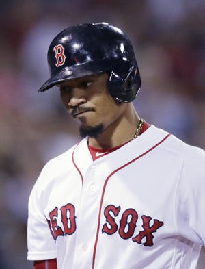Red Sox outfielder Mookie Betts heads to the dugout after striking out with two on to end the fifth inning during Boston's 4-3 loss to the Blue Jays on Monday night at Fenway Park.