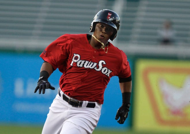 Rafael Devers rounds third and heads home on a Matt Dominguez double in the second inning on Monday night.