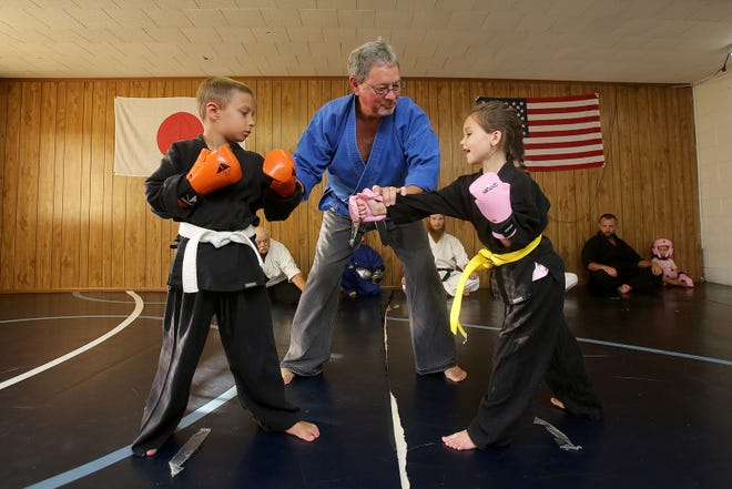 Retired karate instructor Carl Clary works with Payton Tucker, 7, and Eli Love, 7, at Dennis Pettis School of Karate in Boiling Springs on Thursday. Clary is being inducted into the Legends of Carolinas Martial Arts. [Brittany Randolph/The Star]