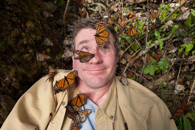 National Geographic Joel Sartore covered with Monarch butterflies in the Sierra Chincua monarch sanctuary in Mexico.