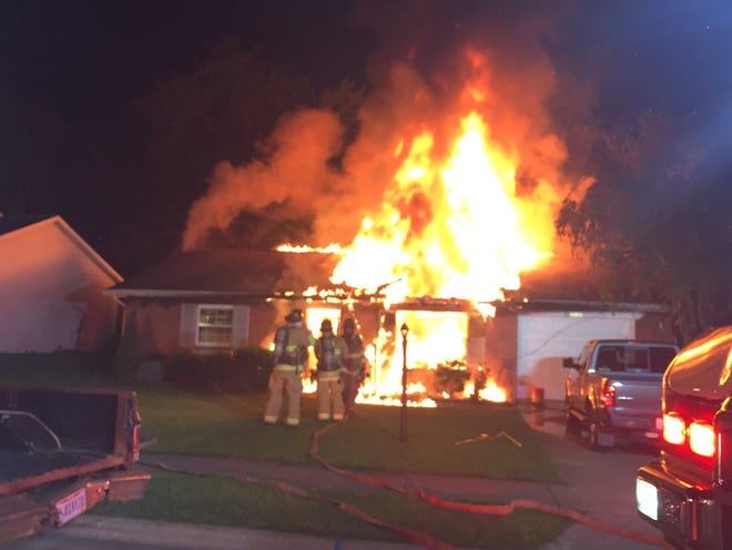 Firefighters with the Newark Fire Department battle a house fire on the 600 block of King Avenue early Tuesday morning. [Newark Fire Department photo]