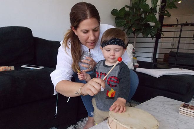 New mother Lara Hogan plays with her son, Zion, at their Topanga, Calif., home. Hogan said she monitors her blood pressure regularly and is determined to stay on top of her health.