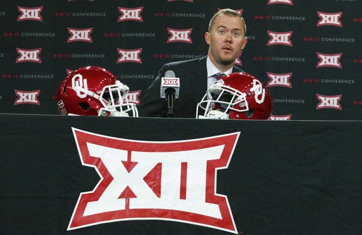 Oklahoma coach Lincoln Riley takes his seat before speaking to reporters at the Big 12 football media day.