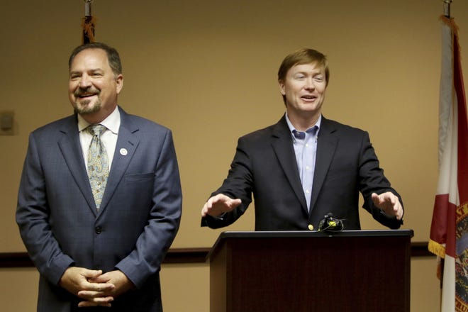 Charles W. Thomas, Pinellas County Tax Collector, left, and Adam Putnam, Commissioner of the Florida Department of Agriculture and Consumer Services, address Pinellas County Tax Collector's office staff at the Pinellas County Courthouse in Clearwater last month. The fee to apply or renew concealed weapons permits in Florida is going down $5. [DOUGLAS R. CLIFFORD/TAMPA BAY TIMES]