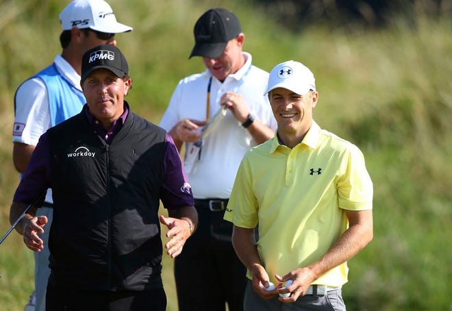 Phil Mickelson of the United States, left, gestures as he talks to Jordan Spieth of the United States during a practice round ahead of the British Open Golf Championship, at Royal Birkdale, Southport, England Tuesday, July 18, 2017.