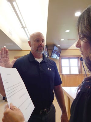 Deputy City Manager Robin Troyer swears in the newest member of the Sault Ste. Marie City Commission. Gregory Collins will serve the unexpired term of Commissioner Jay Gage.