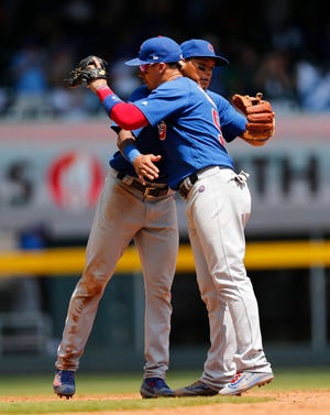 John Bazemore/Associated Press Chicago’s Addison Russell (left) embraces second baseman Javier Baez after the final out. Baez had a 3-run homer the game. in the ninth.