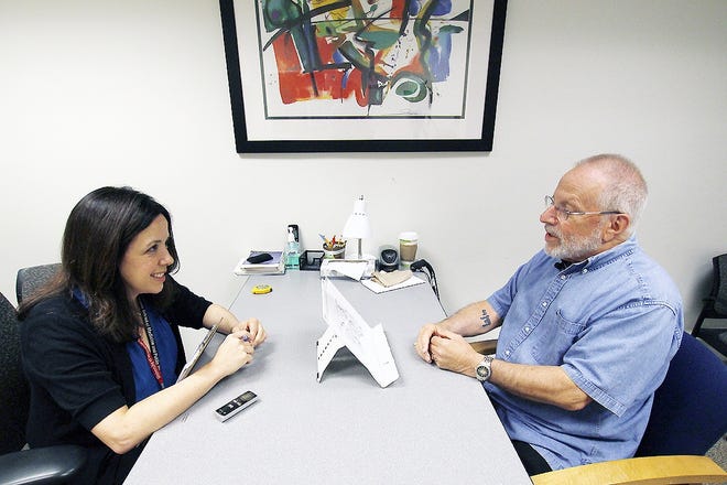In this July 6 photo, Kim Mueller, left, administers a test to Alan Sweet, in which he describes an illustration, as part of a University of Wisconsin-Madison study on dementia. The study found that for some people subtle changes in everyday speech can be correlated with early mild cognitive impairment, which can be a precursor to Alzheimer's disease. [CARRIE ANTLFINGER/ASSOCIATED PRESS]
