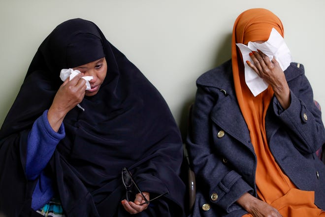 FILE - In this March 16, 2017, file photo, Somali refugees Layla Muali, left, and Hawo Jamile, right, wipe away tears during an interview at the Community Refugee & Immigration Services offices in Columbus, Ohio. Columbus has the country's largest percentage of Somali refugees. The Supreme Court is granting the Trump administration's request to more strictly enforce its ban on refugees, at least until a federal appeals court weighs in. But the justices are leaving in place a lower court order that makes it easier for travelers from six mostly Muslim countries to enter the U.S. (AP Photo/John Minchillo, File)