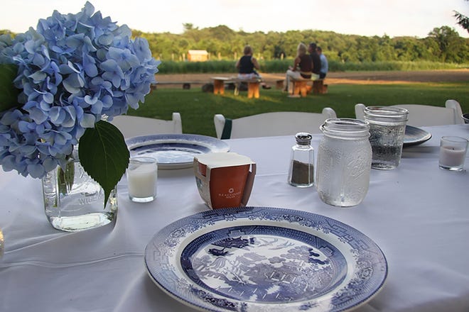 The table is set for a past Farm to Table Dinner overlooking the Share the Harvest Community Garden in Dartmouth. [Courtesy photo]
