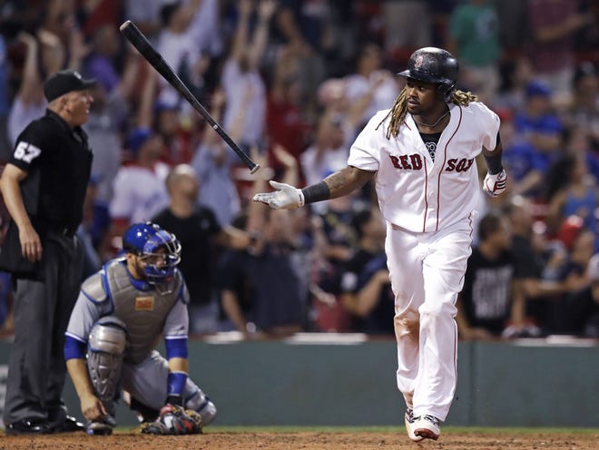 Boston Red Sox's Hanley Ramirez flips his bat after his game-winning solo home run during the 15th inning at Fenway Park in Boston early on Wednesday. [The Associated Press/Charles Krupa]