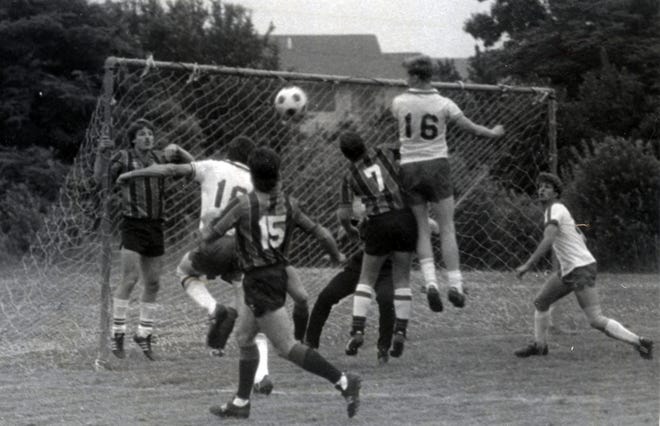 Barnstable players, in white jerseys, move the ball toward the Falmouth Town goal during Cape Cod Amateur Soccer League action in July 1987. [BARNSTABLE PATRIOT FILES/W.B. NICKERSON CAPE COD HISTORY ARCHIVES]
